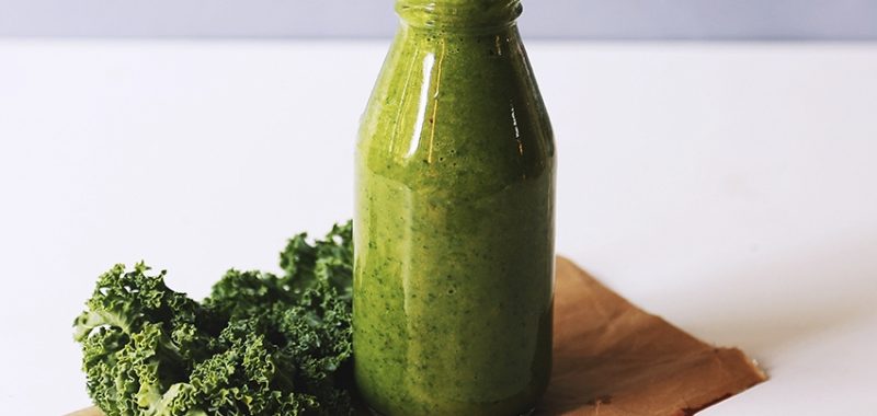 Clear glass bottle filled with broccoli shake 1346347