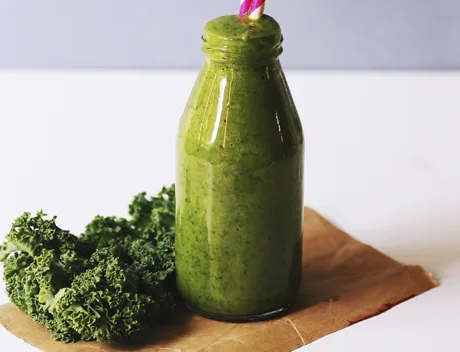 Clear glass bottle filled with broccoli shake 1346347